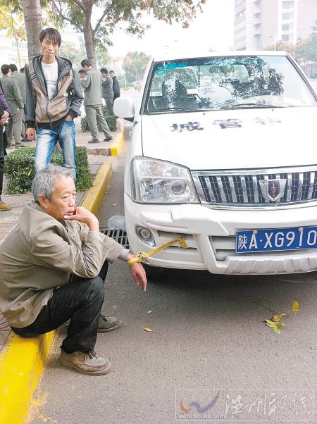 老人电动车被扣自己身绑执法车遭误传被绑